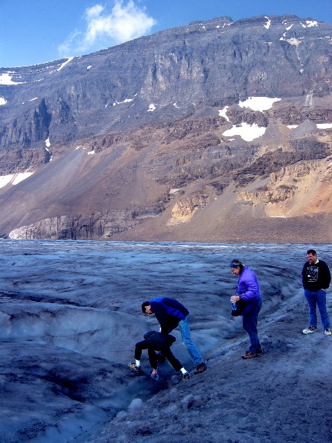 Aron, Ben, Martha get glacier melt water from the Athabasca glacier