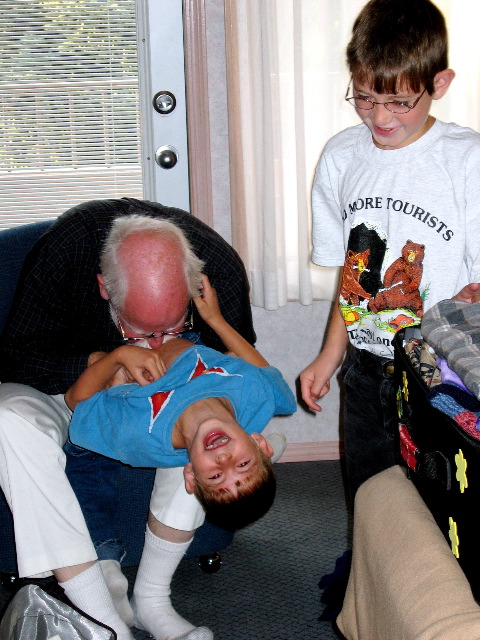 Bop gives Natan a fuzz-berry while Aron watches, Banff